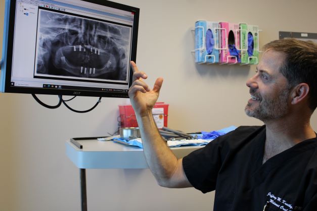 Dr Kratky, an oral surgeon, looking at an xray